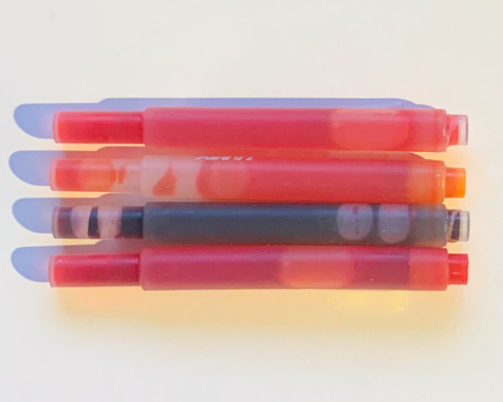 Lamy cartridges - top to bottom: Neon Coral, unidentified orange, Copper Orange, Red