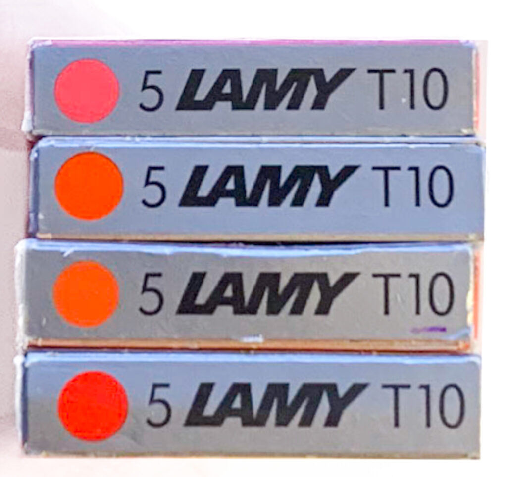 Lamy cartridge boxes - top to bottom: Neon Coral, unidentified orange, Copper Orange, Red